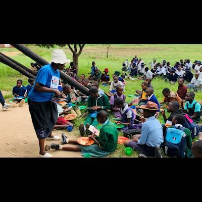 Volunteers feeding children at our centre