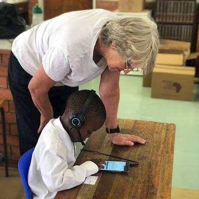 Sarah helping Owami login to his next session