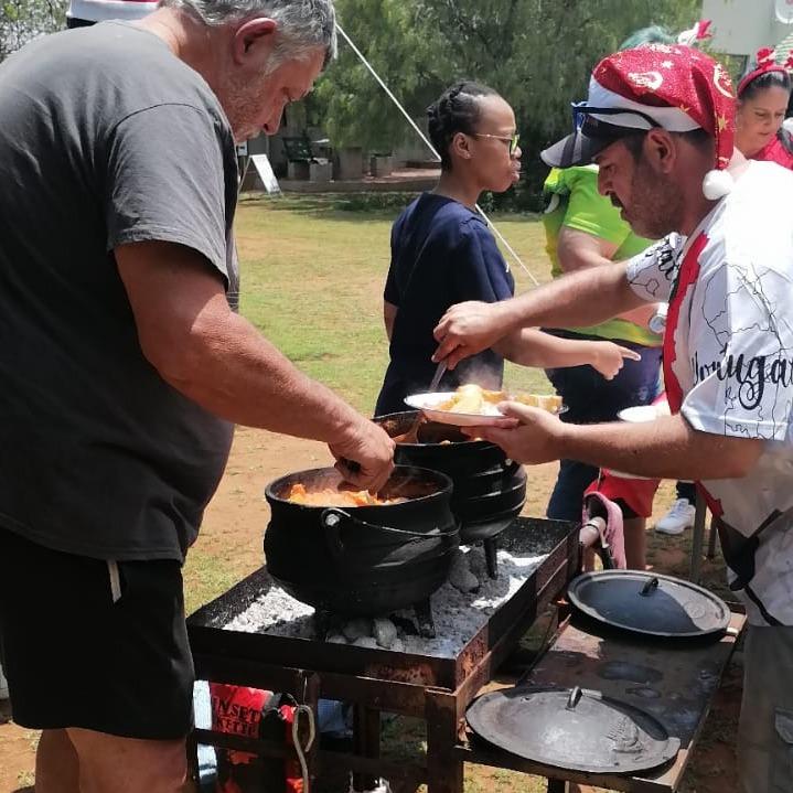 Community members spend Christmas day 2024 cooking for older persons,a special day at Zilisimenye Elderly Home.