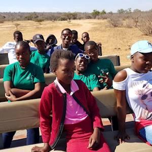 Children visiting a game lodge and offered a free game drive
