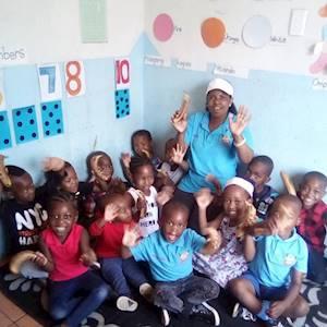 Blooming Paradise students along with their teacher after receiving fruit donations from Mphatlalatsane