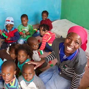 Teacher Grace and her classroom in Olievenhoutbosch (on training with us, Grace is learning how to run a classroom and teach her children well).