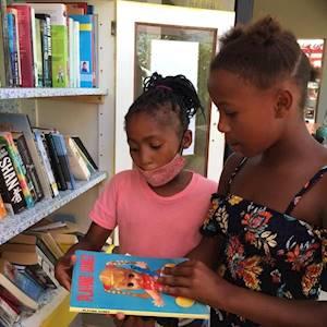 YOUPSA's children enjoying the Little Free Library