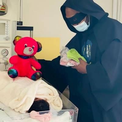 Superhero sharing love with a patient