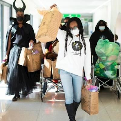 NMCH Superheroes distributing gifts to patients